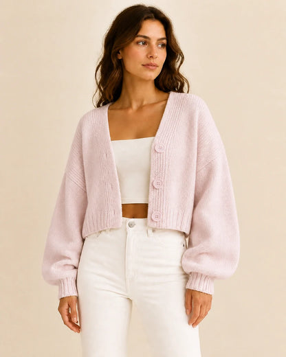 Women's light pink cropped balloon-sleeve cardigan, worn front view