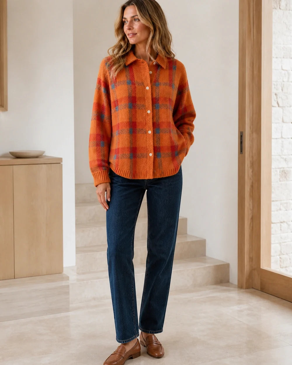 Women's orange checked button-front knit with dark denim styling.