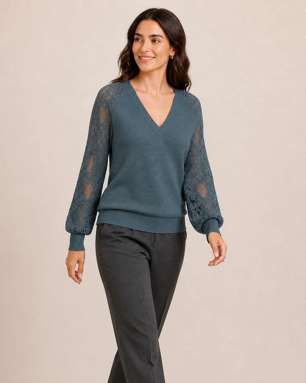 Women's Storm Blue ribbed V-neck sweater with floral lace sleeves, walking view.