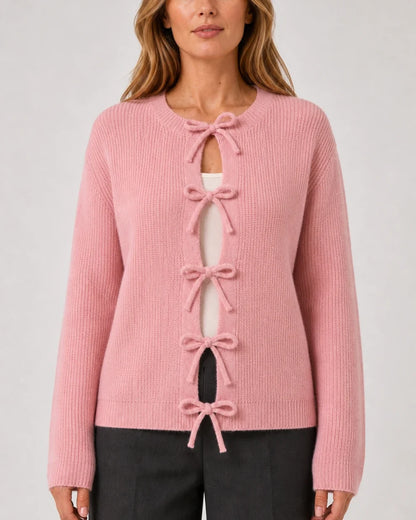 Pink ribbed cardigan with five bow ties, straight front fit.
