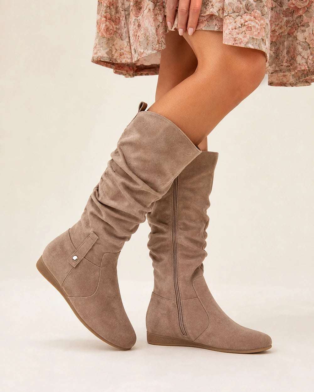Khaki slouch boot showing the suede-effect ruching, small ankle strap and low wedge sole.